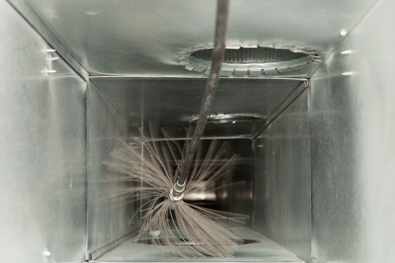 Duct being cleaning by spinning brush